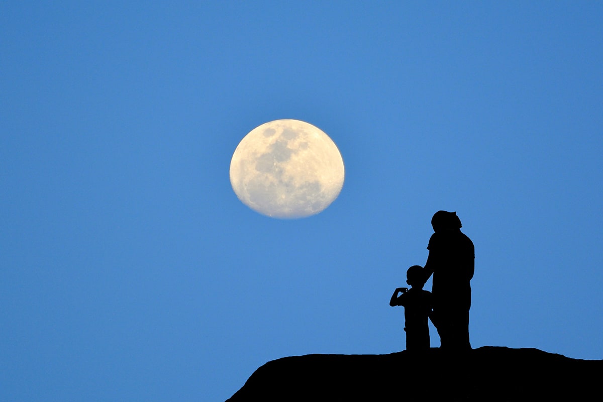 Adult and child viewing the Moon